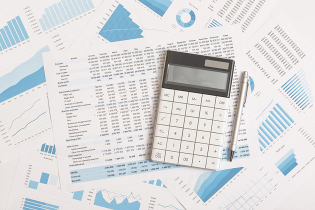 Business Graphs Charts And Calculator On Table